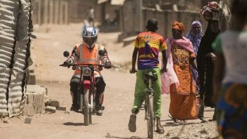 Healthworker on motorcycle, The Gambia