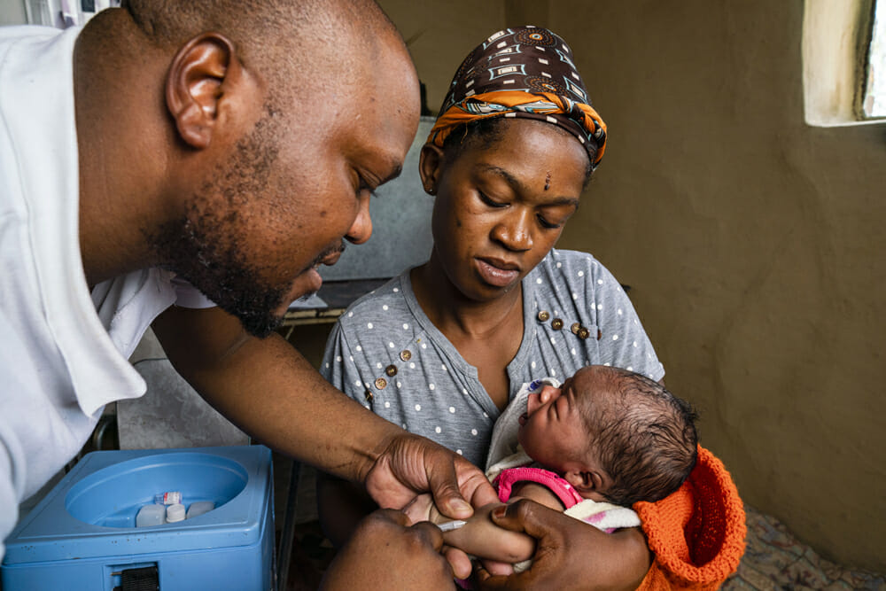 Lesotho, healthworker, mother, baby, newborn, motorcycle